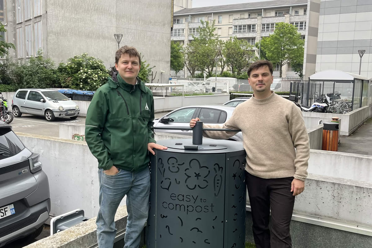 Un gestor de residuos colaborador y un técnico de Easy to Compost delante de una compostadora